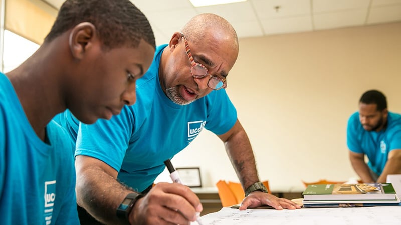 A young man receiving job training